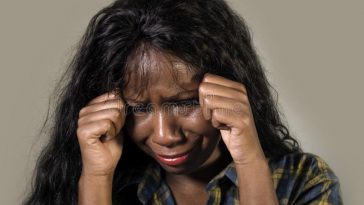 young sad depressed black african american woman crying anxious overwhelmed feeling sick stressed isolated studio b 127611147